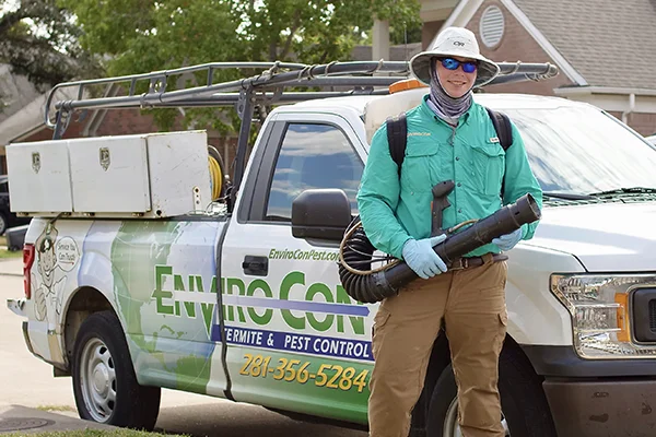 technician standing in front of sprayer