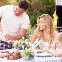 Family barbecuing outside 