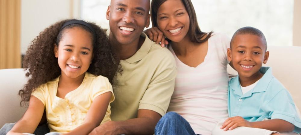 Family sitting on couch 