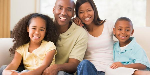 Family sitting on couch 